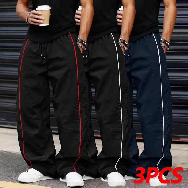 Men’s summer black-and-red quick-dry wide-leg pants with side stripes and a drawstring waist; breathable fabric with a slight wrinkle texture, loose straight cut, side stripe detailing, adjustable cuffs at the leg openings. Suitable for jogging, fitness,