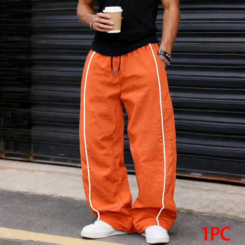 Men’s summer black-and-red quick-dry wide-leg pants with side stripes and a drawstring waist; breathable fabric with a slight wrinkle texture, loose straight cut, side stripe detailing, adjustable cuffs at the leg openings. Suitable for jogging, fitness,
