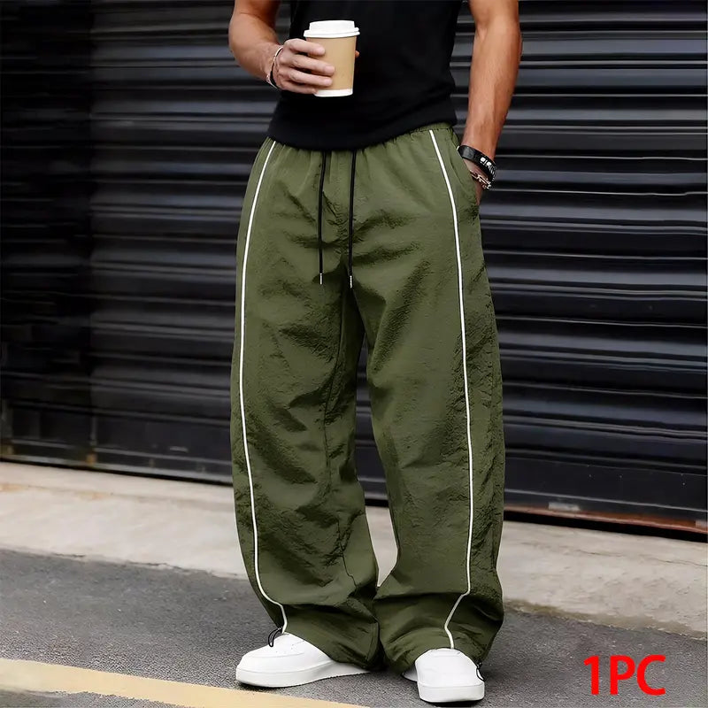 Men’s summer black-and-red quick-dry wide-leg pants with side stripes and a drawstring waist; breathable fabric with a slight wrinkle texture, loose straight cut, side stripe detailing, adjustable cuffs at the leg openings. Suitable for jogging, fitness,
