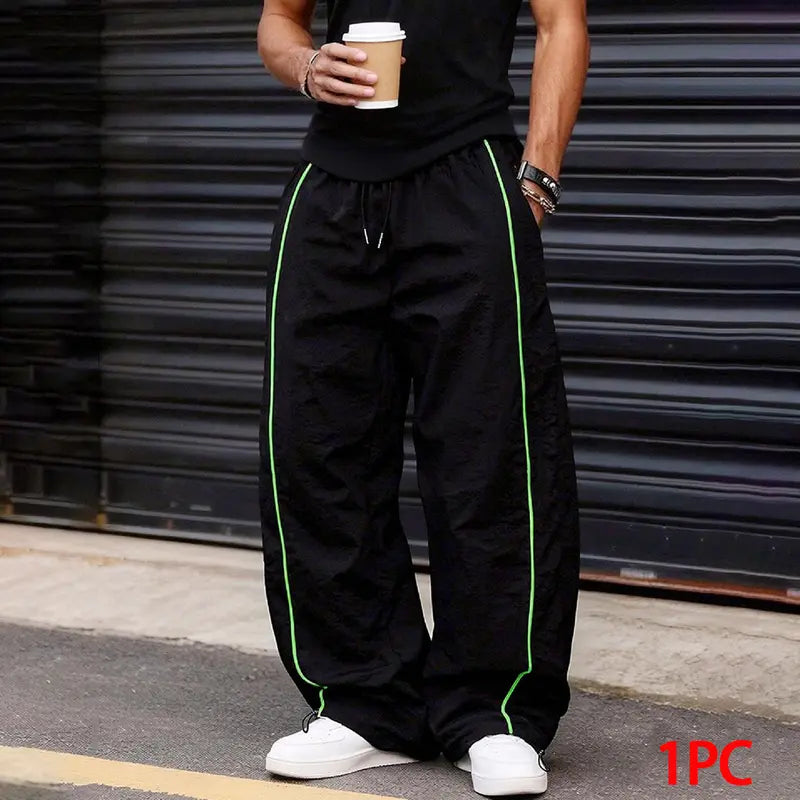Men’s summer black-and-red quick-dry wide-leg pants with side stripes and a drawstring waist; breathable fabric with a slight wrinkle texture, loose straight cut, side stripe detailing, adjustable cuffs at the leg openings. Suitable for jogging, fitness,